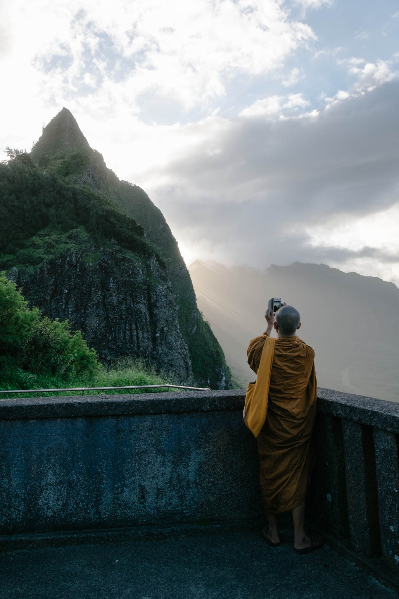 Monk taking a photo with his iPhone